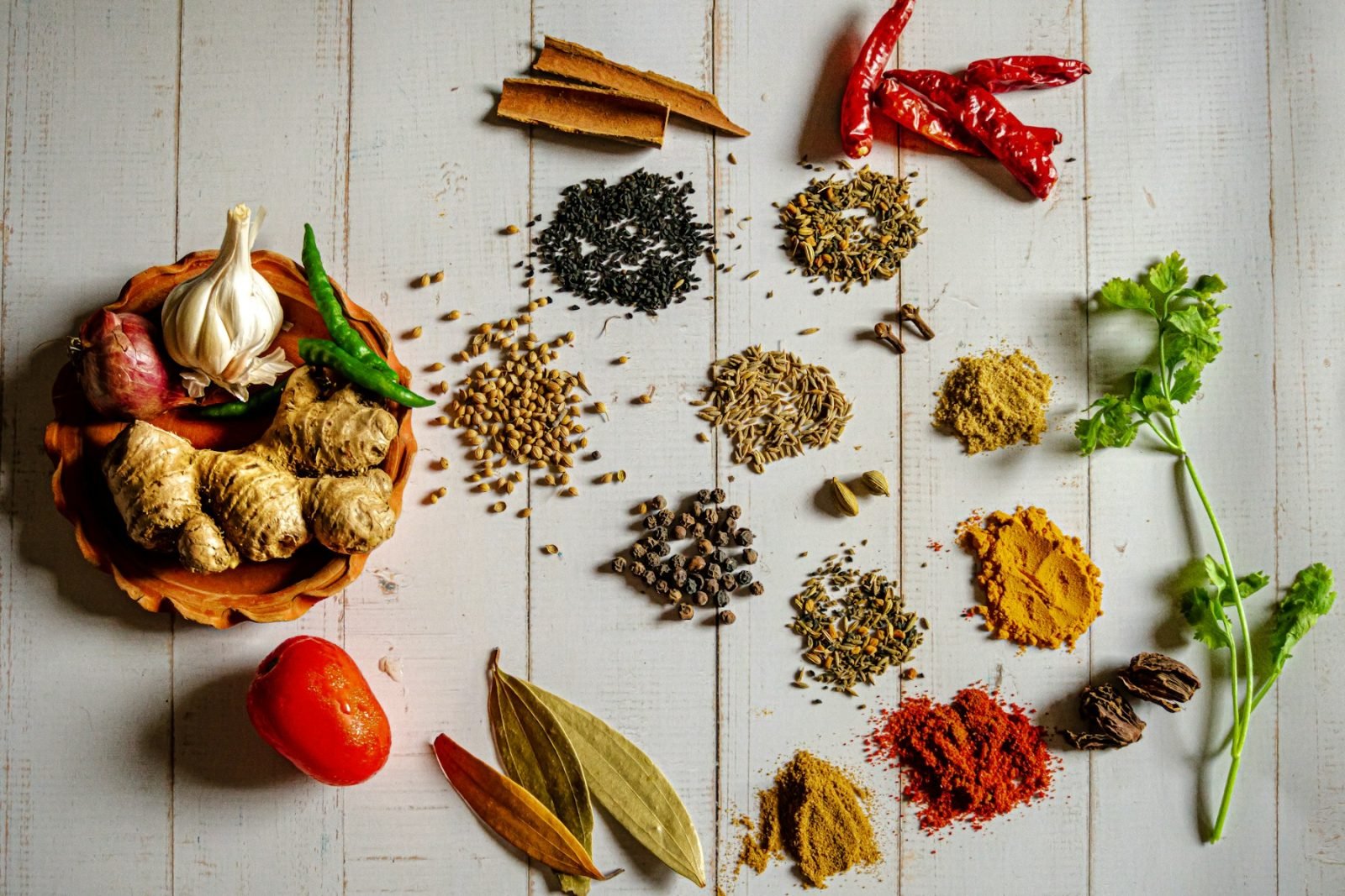 Assorted spices arranged on a white table